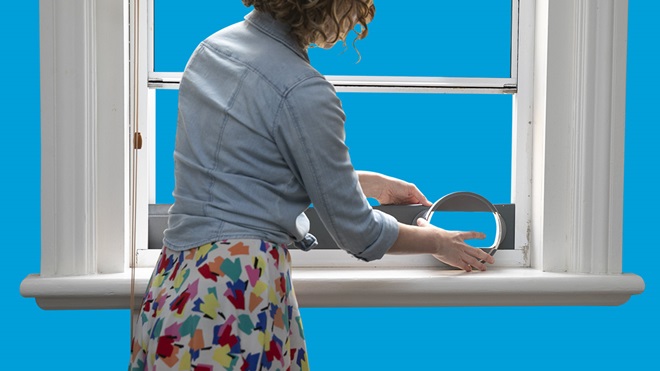 person installing the window sealing plate and nozzle of a portable air conditioner